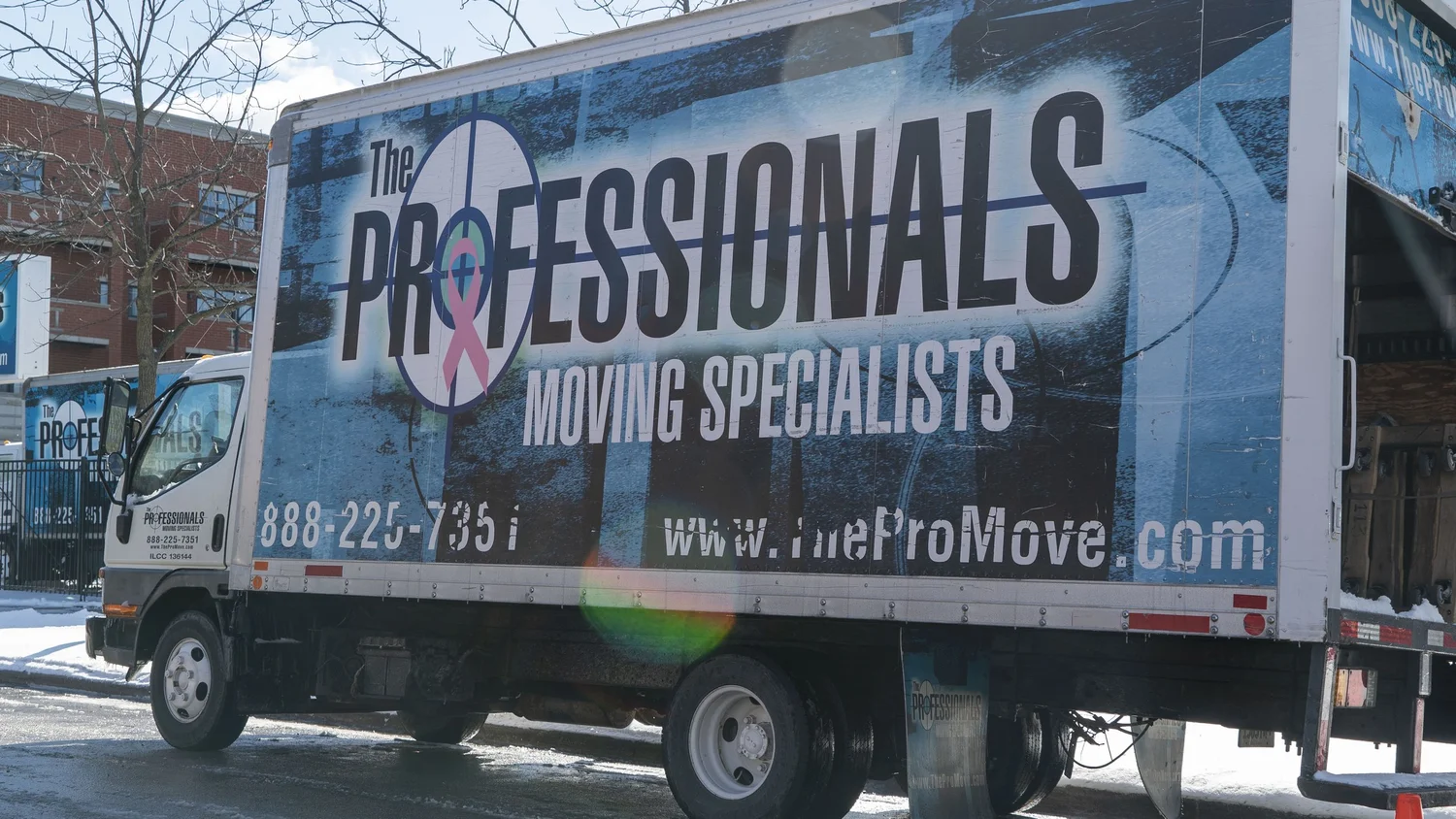 Professional movers carefully loading furniture into a moving truck in Chicago